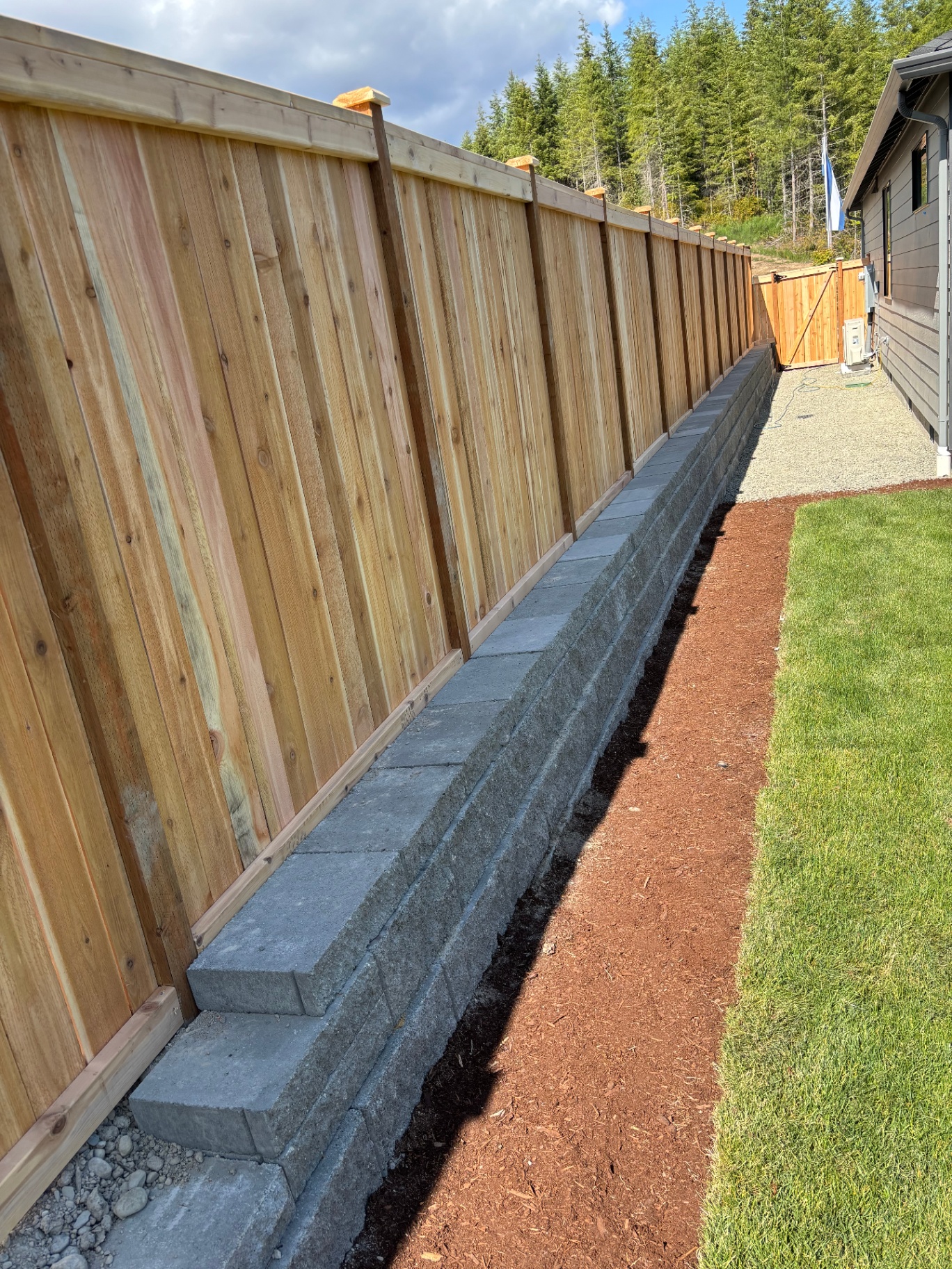 Cedar Fence with Stone Retaining Wall